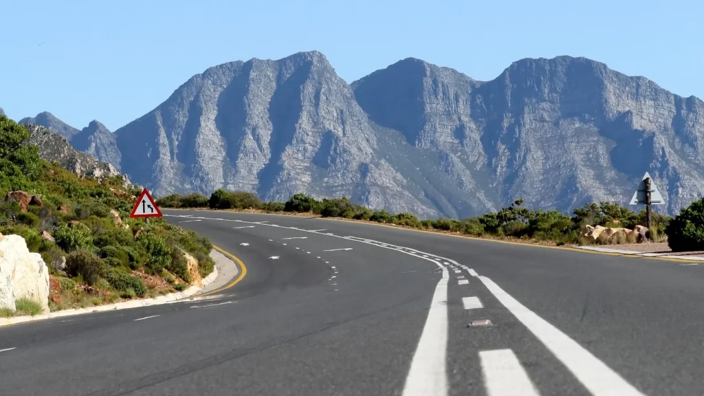 Close up image of road with mountains in background